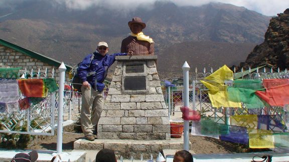 Keith at the Hillary School in Khumjung with a statue of Sir Edmund Hillary. In his hand is a piece of the Moon collected during Apollo 11.